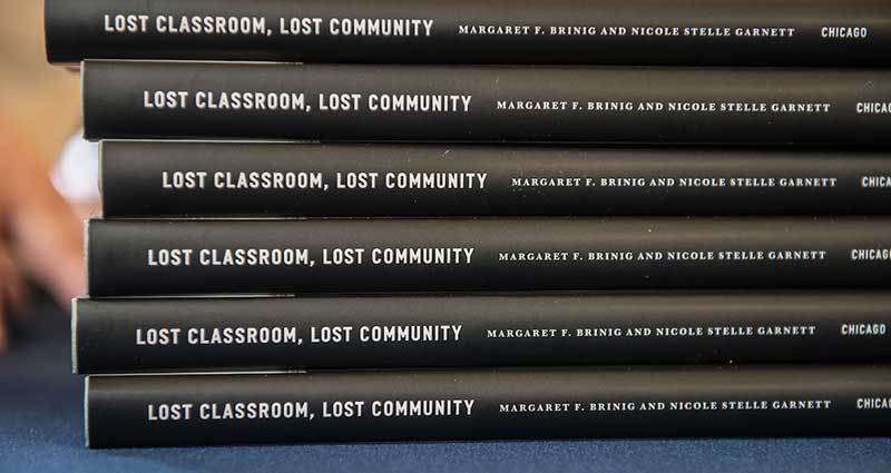 Lost Classroom Lost Community books stacked on top of each other.